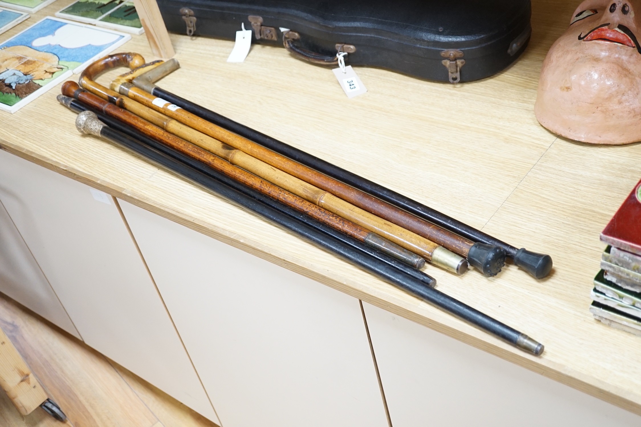 Two Victorian silver mounted walking sticks, a sword stick and three other sticks (6)
